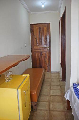 a room with a couch and a wooden door at Pousada Solar Do Triunfo in Triunfo