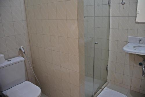 a bathroom with a shower and a toilet and a sink at Pousada Solar Do Triunfo in Triunfo