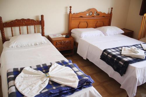 two beds sitting next to each other in a room at Pousada Solar Do Triunfo in Triunfo