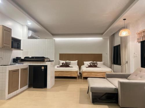 a kitchen and a living room with two beds at Prukrom Lanta Villa in Ko Lanta