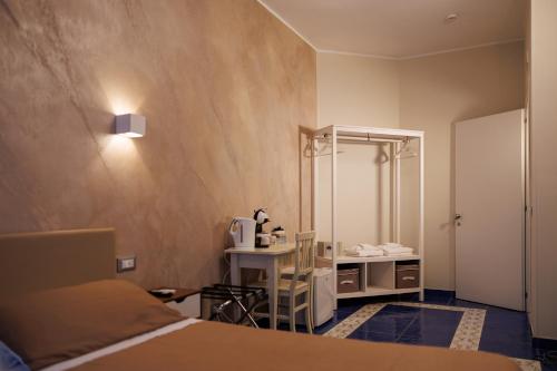 a bedroom with a bed and a bathroom with a mirror at The Reef Sorrento in Sorrento