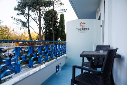 a table and chairs on a balcony with a window at The Reef Sorrento in Sorrento