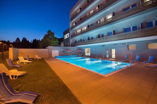 una gran piscina frente a un edificio en Hotel Kraskov Active Resort, en Třemošnice