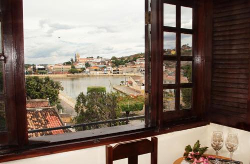 a window with a view of a river at Pousada Solar Do Triunfo in Triunfo