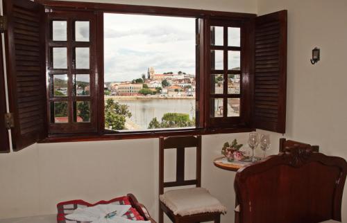 a room with a table and a window with a view at Pousada Solar Do Triunfo in Triunfo