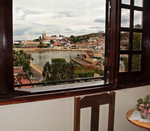 a window with a view of a river at Pousada Solar Do Triunfo in Triunfo