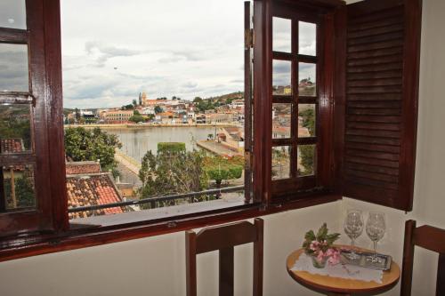 a room with a window with a view of a city at Pousada Solar Do Triunfo in Triunfo