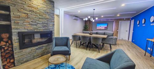 a living room with a fireplace and a table and chairs at The View House in Albufeira