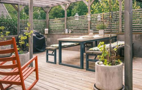 a patio with a table and chairs and potted plants at 2 Bedroom Gorgeous Home In Virserum in Virserum