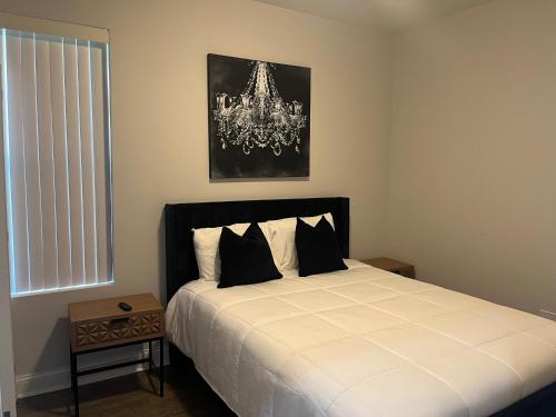 a bedroom with a bed and a chandelier at Mixed Rustic Vibes in Chicago