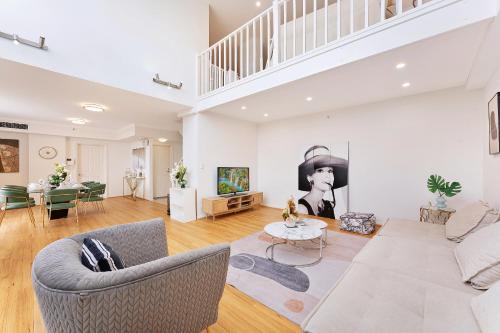 a living room with a couch and a table at Epic CBD city view 3BR penthouse walk to Station&shopping Centre in Sydney