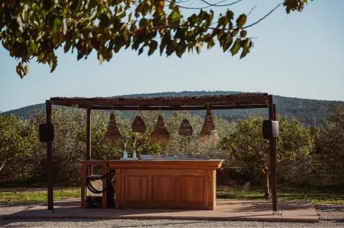 a wooden table under a gazebo at La Farm Baleares in Santa Maria del Camí