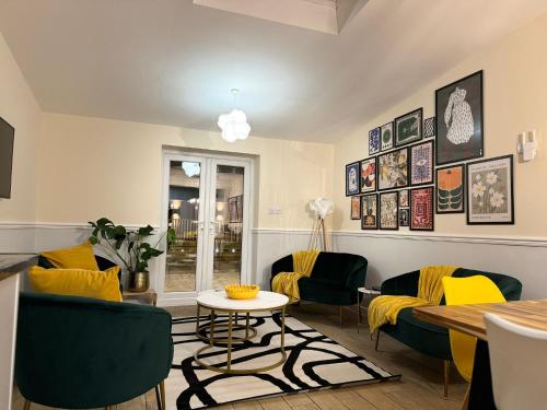 a living room with chairs and a table at Large House for 21 - Nottingham City in Nottingham