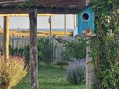 a painting of a bird house in a garden at Tiny house Refugio santa isabel in Colonia Chapadmalal