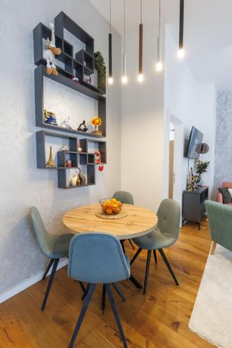 a dining room with a wooden table and chairs at Bjelasnica View Lodge Apartman in Bjelašnica