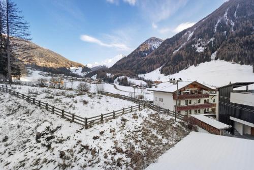 an aerial view of a village in the snow at Pension Waldheim Apartments in San Giacomo