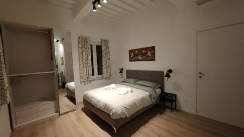 a bedroom with a bed with two towels on it at L'ANGOLO di GALILEO in Pisa