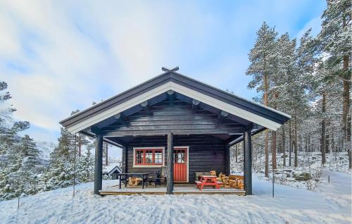 a small cabin in the snow in the woods at Amazing Home In Hovet With Sauna in Hovet