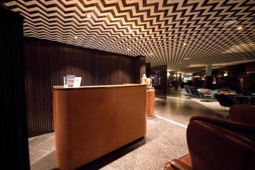 a lobby with a reception desk in a building at Apollo Hotel Amsterdam, a Tribute Portfolio Hotel in Amsterdam