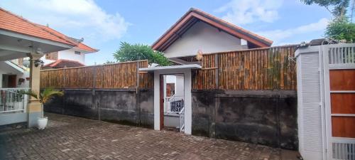 a house with a gate and a fence at Home Villa in Lovina