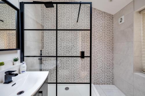 a bathroom with a shower and a white sink at Royal Chester Retreat - Rose Platinum Properties in Chester