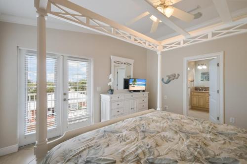 a bedroom with a bed and a television in it at Margarita-Ville in Holmes Beach