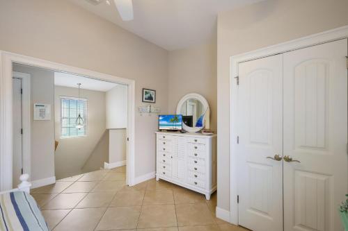 a bedroom with a white dresser and a mirror at Margarita-Ville in Holmes Beach