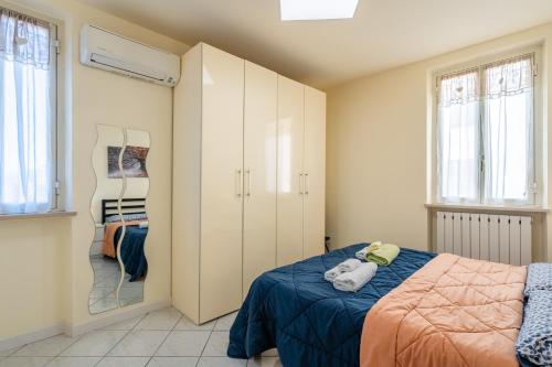 a bedroom with a bed and a closet at La Casina Gialla Independent House in Lucca