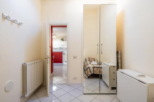 a bathroom with white walls and a mirror at La Casina Gialla Independent House in Lucca
