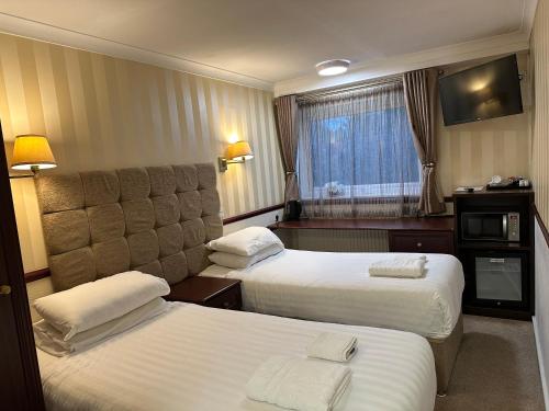 Ένα ή περισσότερα κρεβάτια σε δωμάτιο στο NormanHurst Hotel