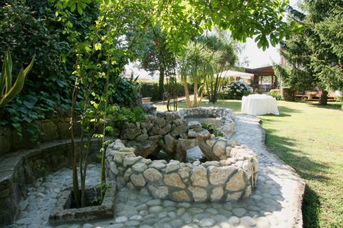 a rock garden with a pond in a yard at Il Casale di Riardo Luxury B&B in Riardo