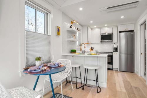 a kitchen with a table and chairs and a refrigerator at Walk to Beach Shopping and Dining in Provincetown