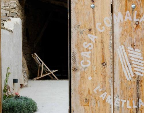 an open door of a wooden building with a window at Casa Comalats in Ametlla