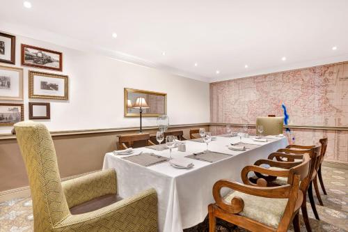a dining room with a long table and chairs at Protea Hotel by Marriott Blantyre Ryalls in Blantyre