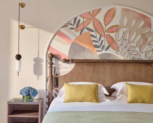 a bedroom with a large bed with yellow pillows at Grand Hyatt La Manga Club Golf & Spa in La Manga del Mar Menor