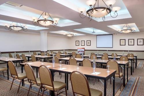 a room with tables and chairs and a projection screen at Protea Hotel by Marriott Blantyre Ryalls in Blantyre