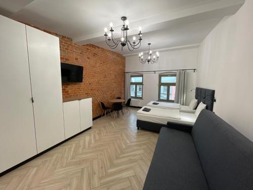 a living room with a couch and a dining room at Pod Błękitnymi Podkowami in Wrocław