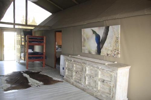 a room with a painting of a bird on the wall at Kubu & Kwena Lodge in Katima Mulilo