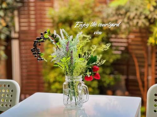 a vase filled with flowers sitting on a table at House near Shinjuku with parking & courtyard in Tokyo
