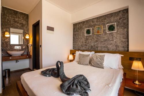 a bedroom with a bed with a black robe on it at Li Mango in Tigaki