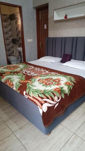 a bed with a colorful blanket on top of it at Australia villa fully Ac Fridge Tv Wifi in Bathinda