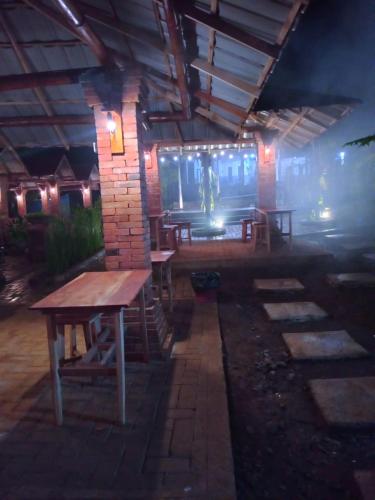 a group of tables in a building at night at Puri kahuripan in Pagungjoho