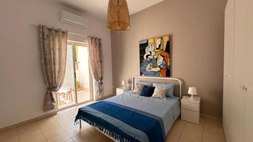 a bedroom with a bed and a painting on the wall at Centrally Located Gzira in Il-Gżira