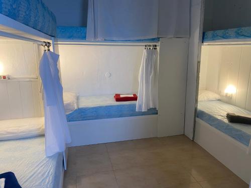 a bedroom with two bunk beds and a window at Backpacker las eras II in Las Eras