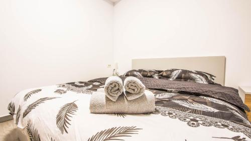 a bedroom with a bed with towels on it at Complex panoramic Mihai Bravu cu internet de mare viteza si parcare gratuita in Bucharest