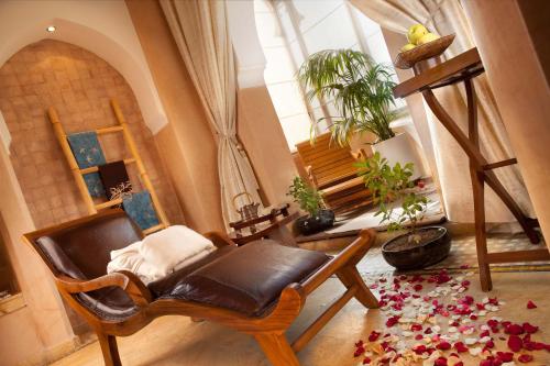a living room with a chair and a large window at Pickalbatros Hôtel Du Golf - Adults Friendly 16 Years Plus- All-Inclusive in Marrakech