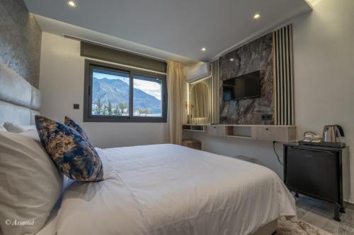 a bedroom with a large bed and a window at Luxury Chaouen in Chefchaouene