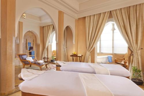 a hotel room with three beds in a room at Pickalbatros Hôtel Du Golf - Adults Friendly 16 Years Plus- All-Inclusive in Marrakech