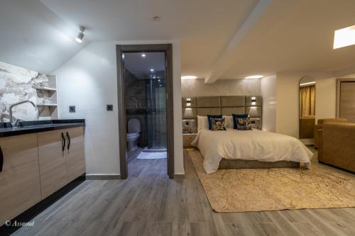 a bedroom with a bed and a bathroom at Luxury Chaouen in Chefchaouene