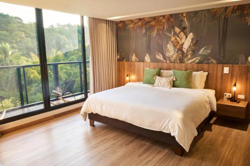 a bedroom with a large bed and a large window at HYPE STATES Cali in El Peñón